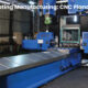 A factory scene showing a CNC Plano Miller machine.